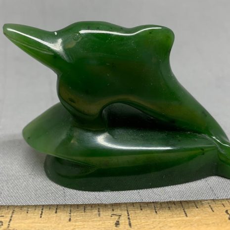dolphin_1 Dolphin carving by Peter Cleghorn - Alexandra, New Zealand 2.16 oz. 61g - 2.25" x 1.625" x .875" Singed, high quality carving and greenstone nephrite jade from New Zealand, fantastic lines on this jumping dolphin riding the rest of a wave.